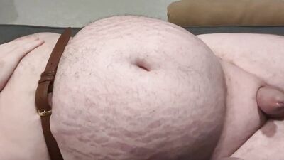 A small-dicked fat man is playing with his belly button
