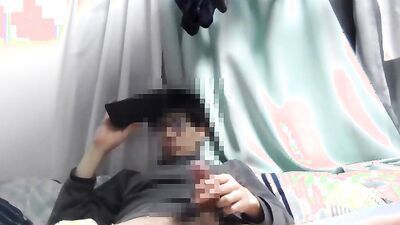 Asian guy is watching gay porn on his phone while jerking off