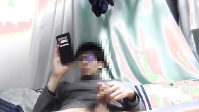 Asian guy is watching gay porn on his phone while jerking off