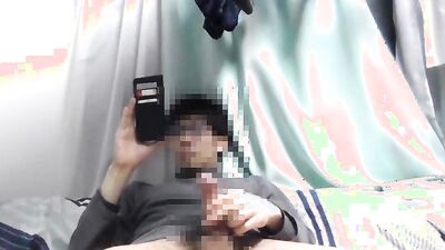 Asian guy is watching gay porn on his phone while jerking off