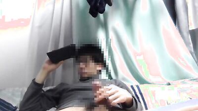 Asian guy is watching gay porn on his phone while jerking off