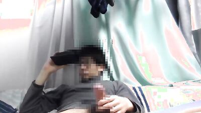 Asian guy is watching gay porn on his phone while jerking off