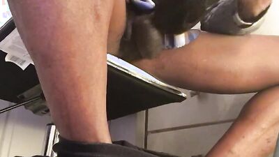 Black guy is filmed under the table while playing with his cock
