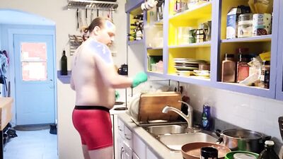 Gay dude is making a breakfast shirtless in the kitchen