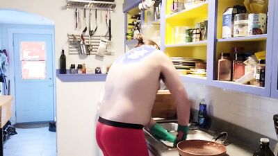 Gay dude is making a breakfast shirtless in the kitchen