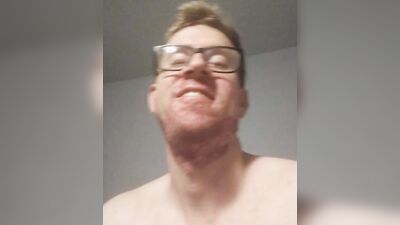Nerdy guy poses naked on the floor and plays with his cock
