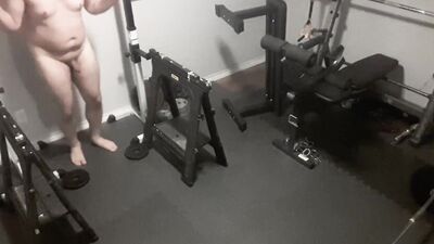 Exhibitionistic chubby guy is working out naked in the gym