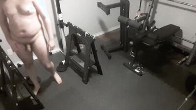 Exhibitionistic chubby guy is working out naked in the gym