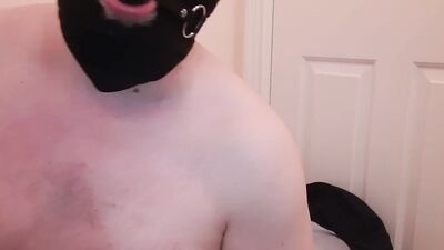 chubby masked guy is playing with his cock in front of the camera