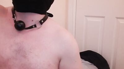 chubby masked guy is playing with his cock in front of the camera
