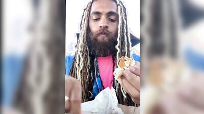 Bearded guy Rock Mercury is talking with his fans while stuffing