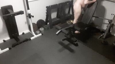 Chubby guy is naked while working out in the gym