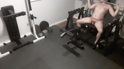 Chubby guy is naked while working out in the gym