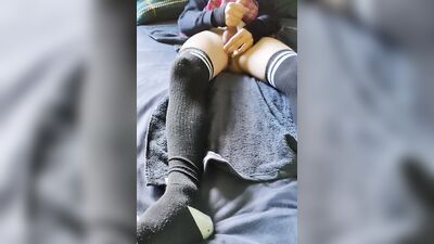 Femboy in long socks is playing with his dick and balls