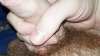 Hairy man is filming his pecker while stroking it for the camera