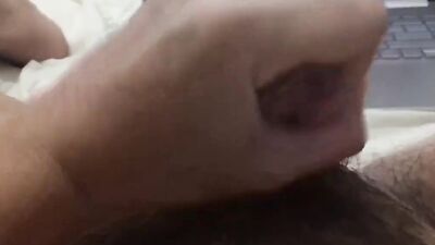 Horny lad is squeezing his cock and jizzing all over his tummy