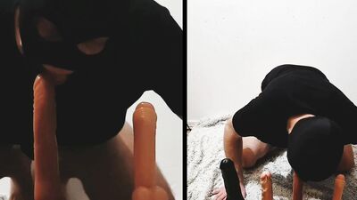 Masked gimp is stroking his cock while sitting on a sex toy