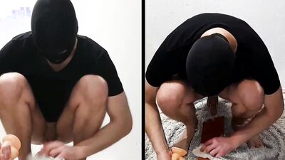Masked gimp is stroking his cock while sitting on a sex toy