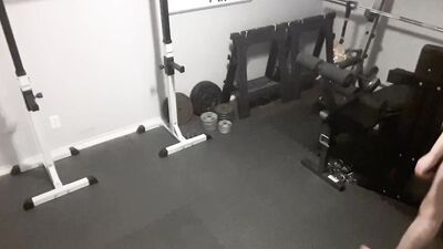A security camera films a naked guy while he's working out