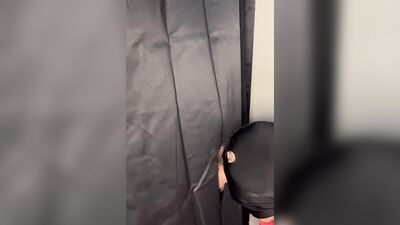 Masked gimp grabs a boner and sucks it through a gloryhole