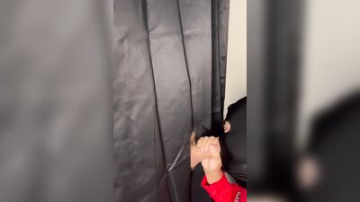 Masked gimp grabs a boner and sucks it through a gloryhole