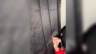 Masked gimp grabs a boner and sucks it through a gloryhole