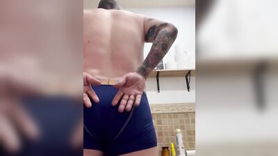 Tattooed man pulls his pants down to play with that hard pecker