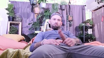 Guy is watching porn on his phone while squeezing that hard dick