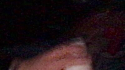 Masked gimp wraps his lips around a massive dildo and sucks it