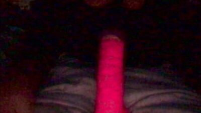 Masked gimp wraps his lips around a massive dildo and sucks it