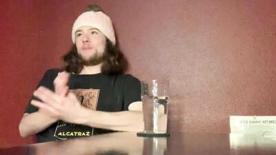Long-haired guy gets naked and plays with himself in the bedroom