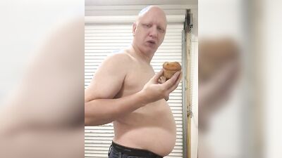 Chubby guy shows his belly while stuffing on the webcam