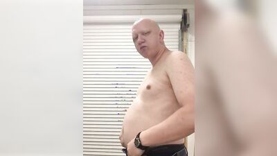 Chubby guy shows his belly while stuffing on the webcam