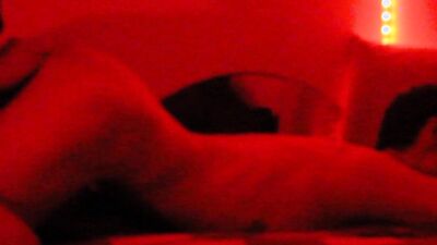 Two horny gay chums are lovemaking in the dark red room