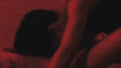 Two horny gay chums are lovemaking in the dark red room