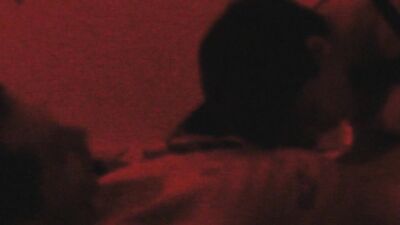 Two horny gay chums are lovemaking in the dark red room