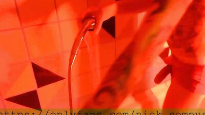 Sexy hell-boy jerking off in the shower. Cum flows over the rubber boot.