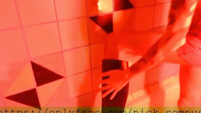 Sexy hell-boy jerking off in the shower. Cum flows over the rubber boot.