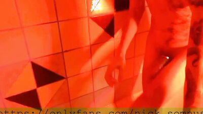 Sexy hell-boy jerking off in the shower. Cum flows over the rubber boot.