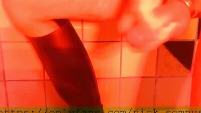 Sexy hell-boy jerking off in the shower. Cum flows over the rubber boot.