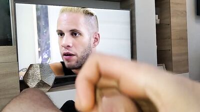 Horny dude is stroking his huge cock while watching a porn