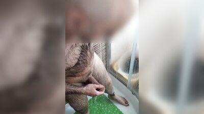 Amateur bloke is stroking his hard prick while taking a shower