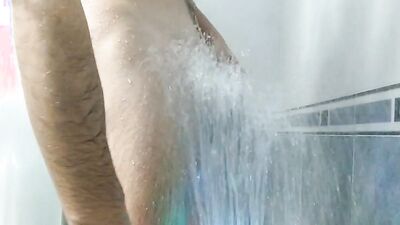 Amateur lad is playing with his huge dick while taking a shower