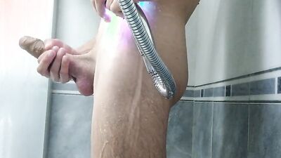 Amateur lad is playing with his huge dick while taking a shower