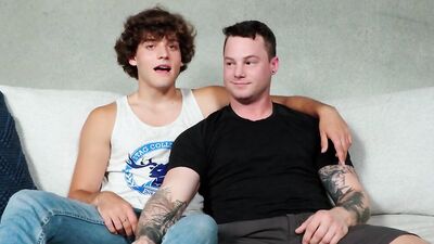 Tattooed chap is riding his horny mate's prick on the couch