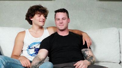 Tattooed chap is riding his horny mate's prick on the couch