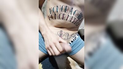 Tattooed bloke is stretching his prick in front of the camera