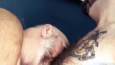Two horny bears are having sex in this raw scene