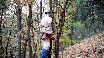 Skinny masked teen is playing with a pecker inside the forest