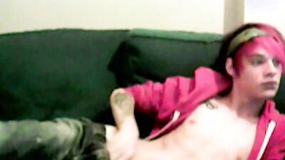 Skinny twink is playing with his cock on the couch